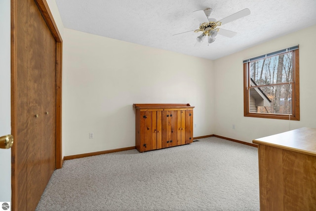 interior space with ceiling fan and a textured ceiling