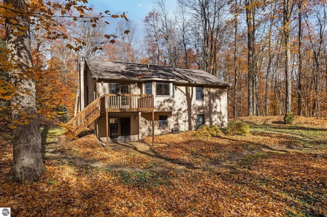 rear view of property with a deck and central air condition unit