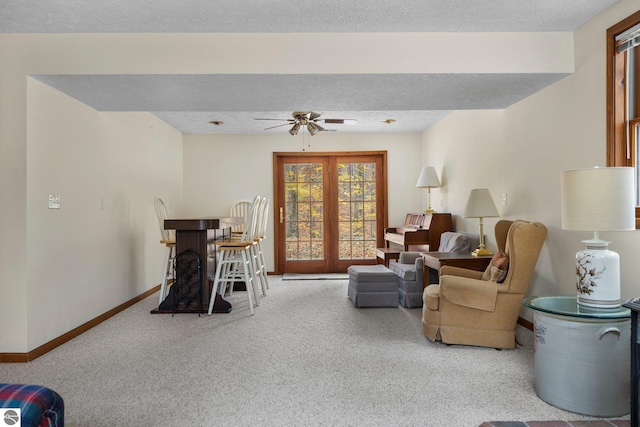 carpeted living room featuring a textured ceiling and ceiling fan