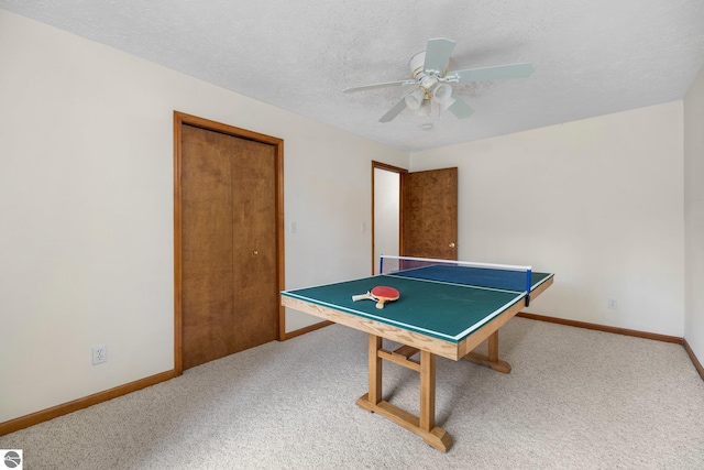 game room featuring ceiling fan, carpet, and a textured ceiling