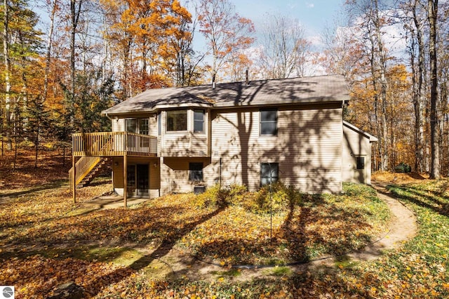 rear view of property with a wooden deck