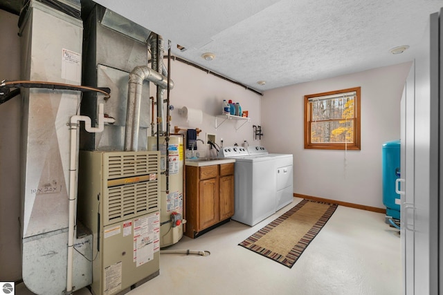 laundry room with cabinets, a textured ceiling, heating unit, water heater, and independent washer and dryer