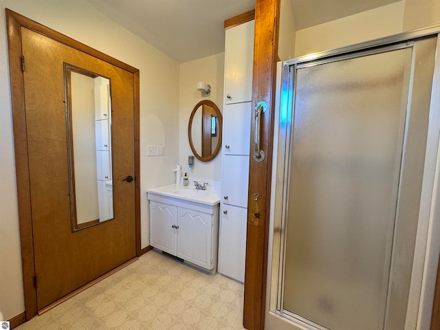 bathroom featuring vanity and a shower with shower door