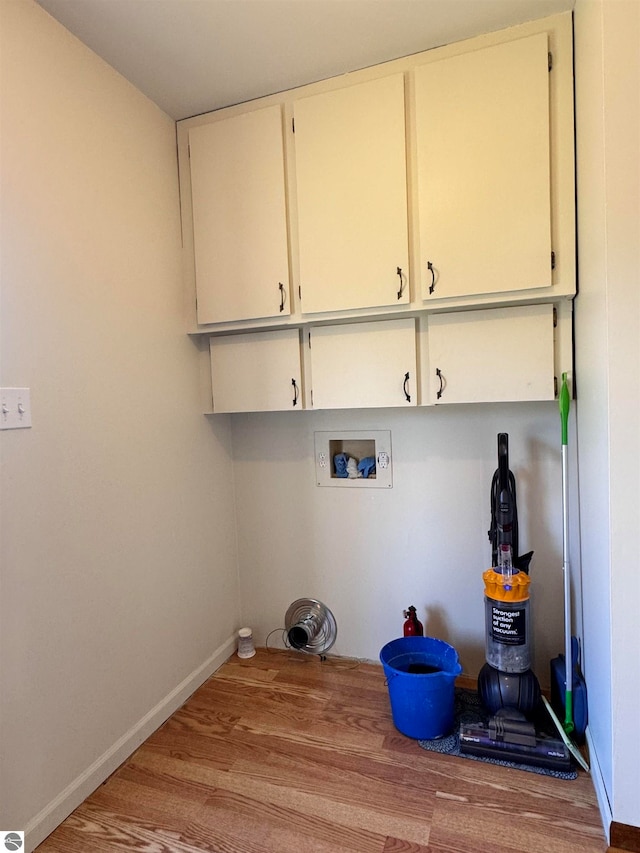 laundry area with cabinets, washer hookup, and wood-type flooring