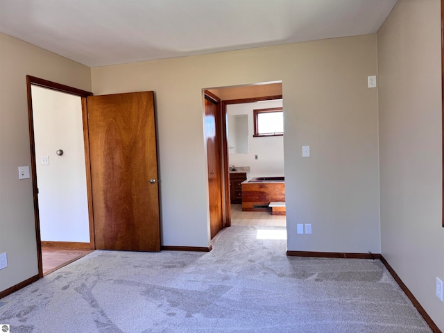 unfurnished bedroom with light carpet