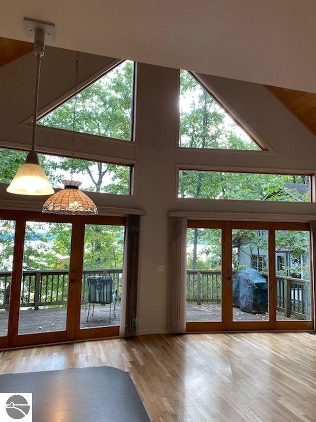4709 State Park Hwy, Interlochen, MI 49643 - doorway featuring high vaulted ceiling, wood finished floors, wood ceiling, and french doors