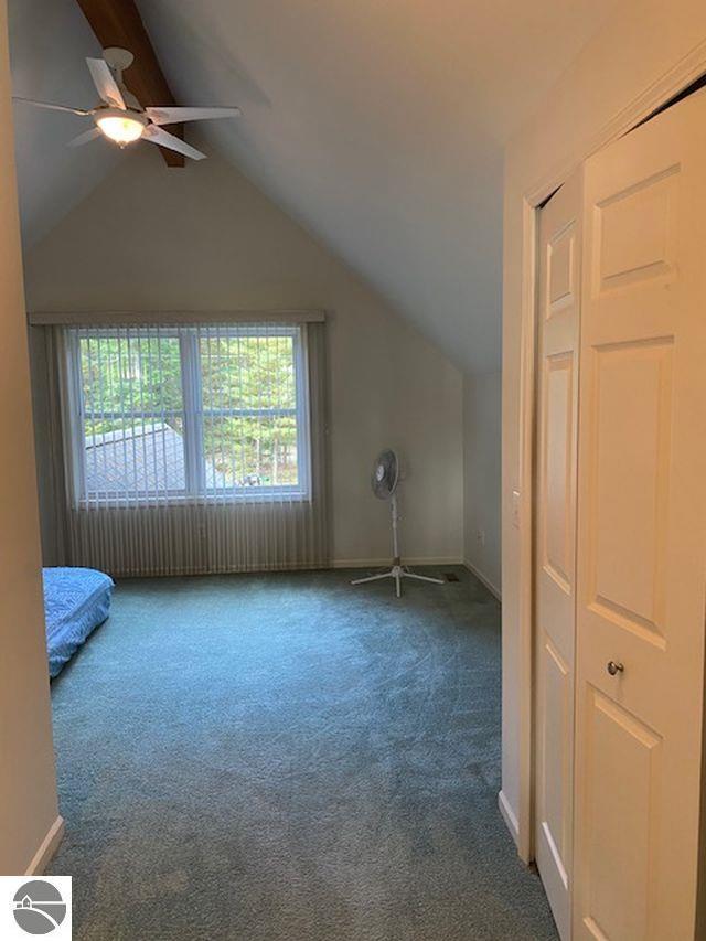 4709 State Park Hwy, Interlochen, MI 49643 - additional living space with carpet flooring, lofted ceiling, ceiling fan, and baseboards