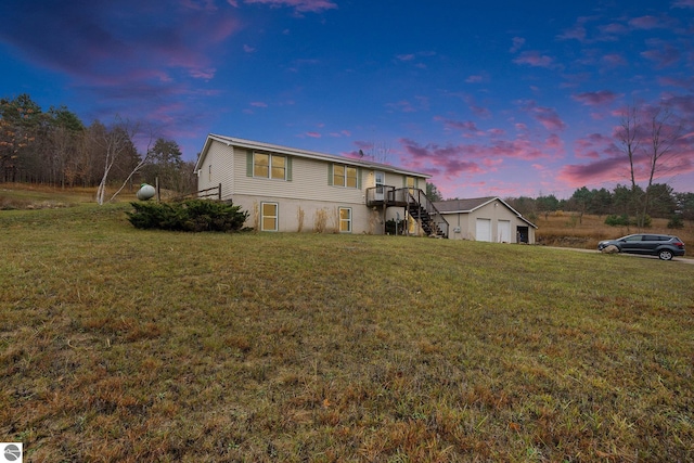 view of front of property with a yard, a garage, and a wooden deck