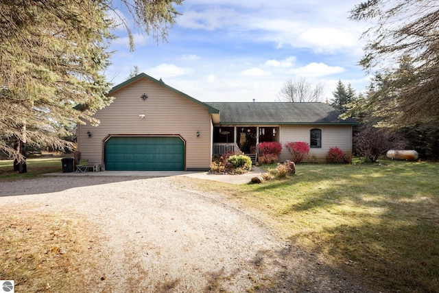 single story home featuring a porch, a garage, and a front yard