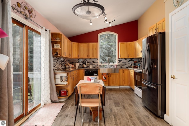 kitchen with stainless steel fridge, light hardwood / wood-style floors, vaulted ceiling, and white range with electric stovetop