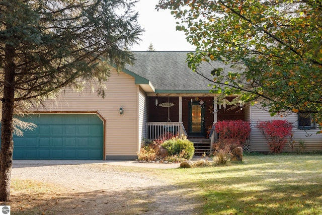 view of front facade featuring a garage, a front yard, and a porch