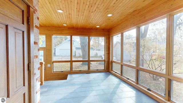 unfurnished sunroom featuring wooden ceiling and plenty of natural light