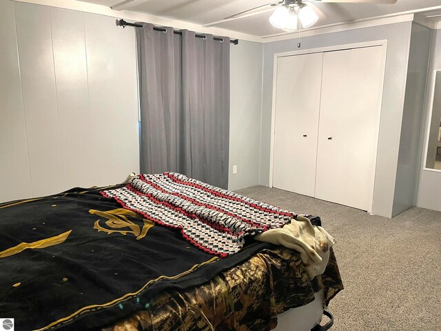 bedroom with a closet, ceiling fan, and carpet floors