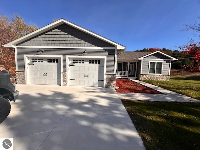 craftsman house with a front lawn and a garage