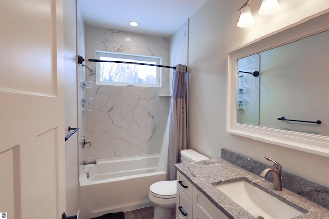 full bathroom with toilet, vanity, and shower / tub combo