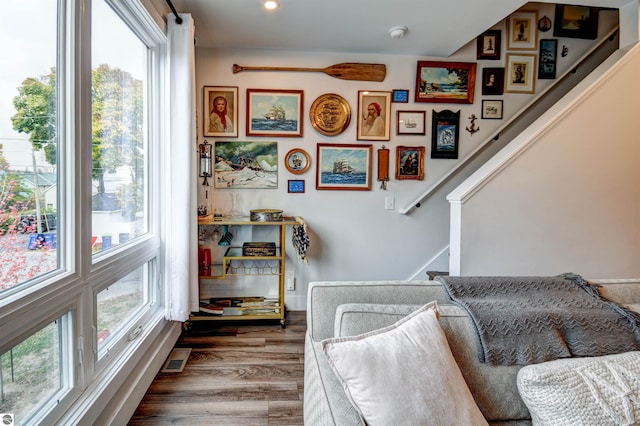 stairway featuring hardwood / wood-style floors and a healthy amount of sunlight