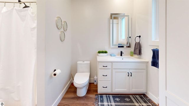 bathroom featuring vanity, toilet, and hardwood / wood-style floors