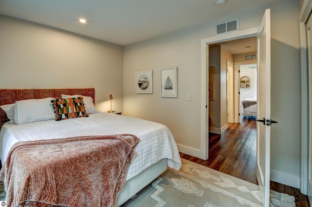 bedroom with dark wood-type flooring