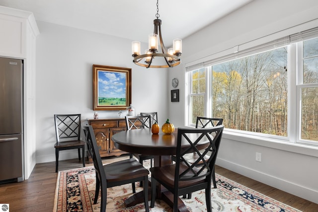 dining space with a chandelier, dark hardwood / wood-style flooring, and a wealth of natural light