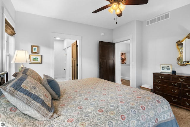 bedroom with ensuite bath and ceiling fan