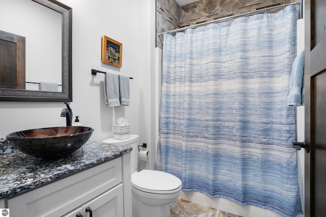 bathroom with curtained shower, vanity, and toilet