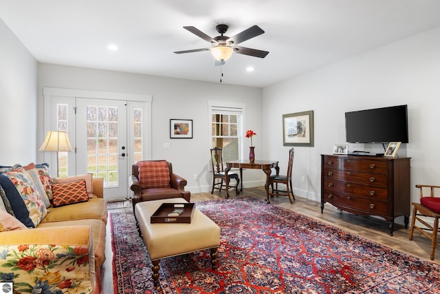 living room featuring ceiling fan and hardwood / wood-style floors