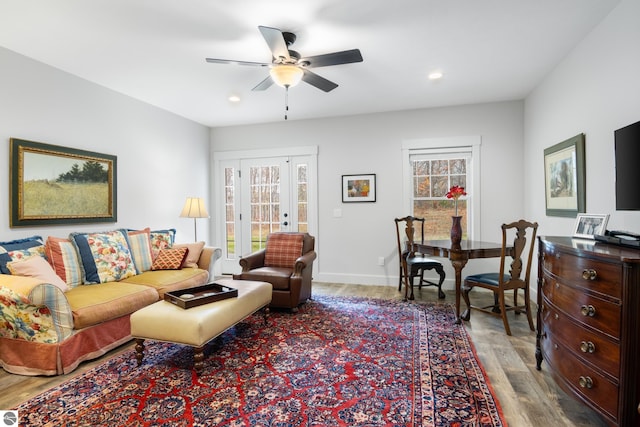 living room with light wood-type flooring and ceiling fan