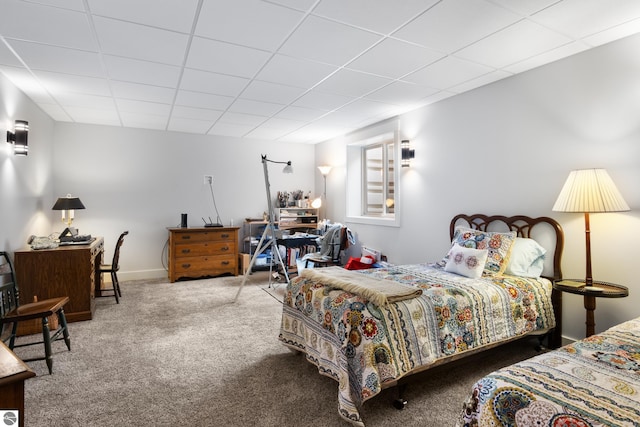 carpeted bedroom with a paneled ceiling