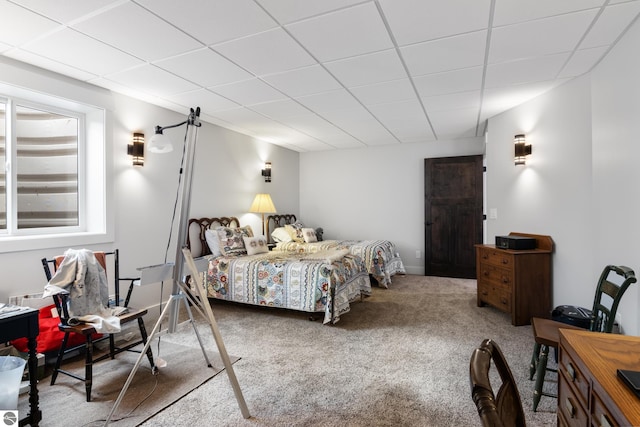 carpeted bedroom featuring a paneled ceiling