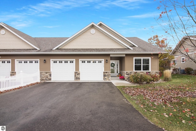 view of front of house featuring central AC unit and a garage