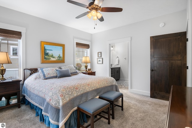 carpeted bedroom with ceiling fan and connected bathroom