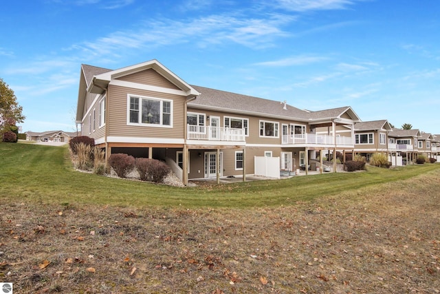 rear view of property with french doors, a yard, and a patio area