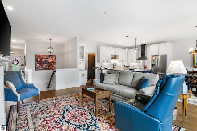 living room featuring sink and hardwood / wood-style flooring