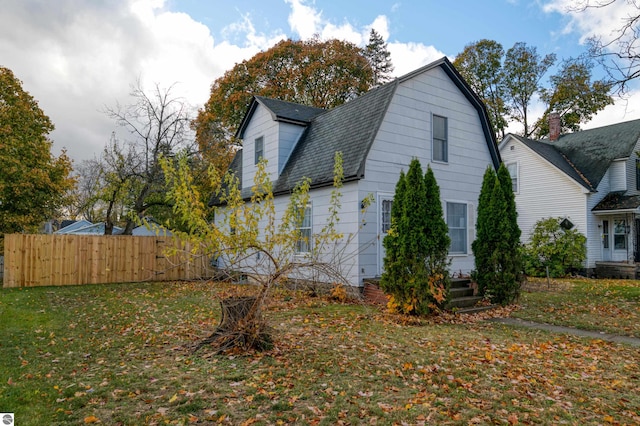 view of side of home featuring a yard