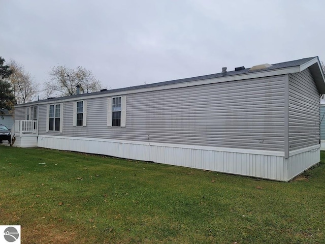 view of side of home featuring a yard