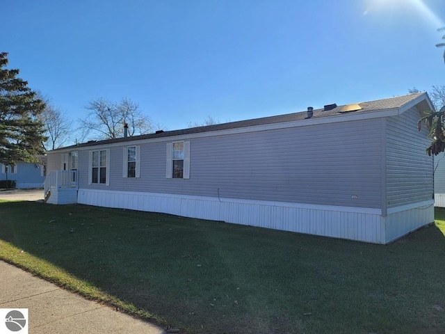 view of side of home featuring a yard