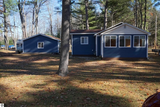 back of house with a lawn