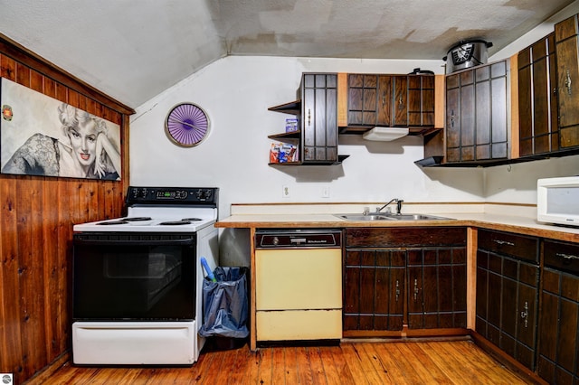 kitchen featuring light hardwood / wood-style floors, sink, white appliances, dark brown cabinets, and lofted ceiling