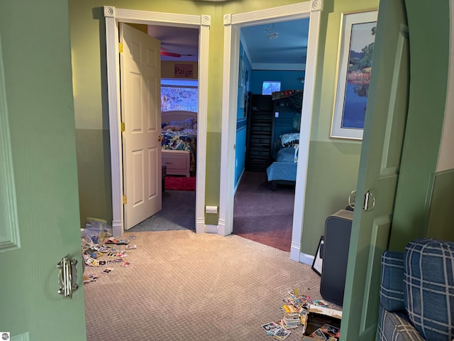 corridor with carpet floors and crown molding