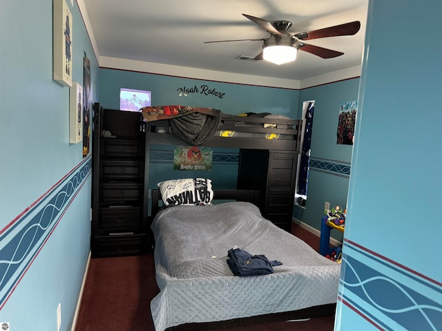 bedroom featuring dark colored carpet and ceiling fan