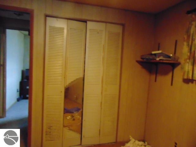 interior space featuring a closet and wood walls