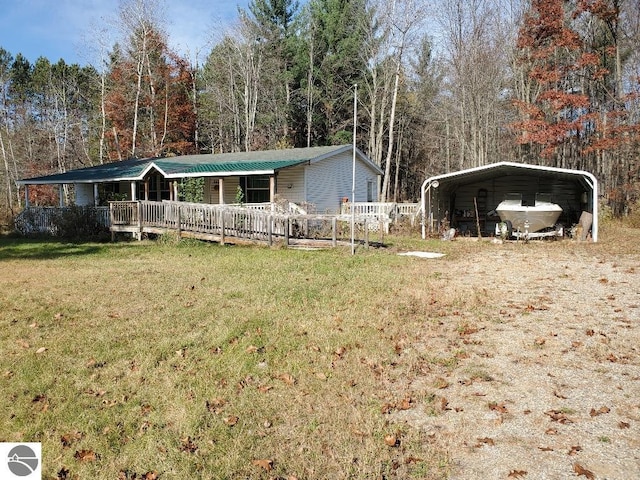 view of front of home featuring a wooden deck, a front lawn, and a carport