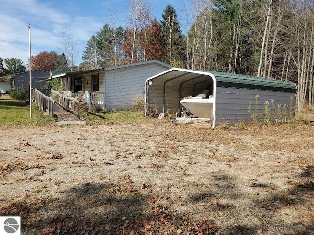 2824 Badger Rd, Beaverton, MI 48612 - view of outbuilding with a detached carport and covered porch