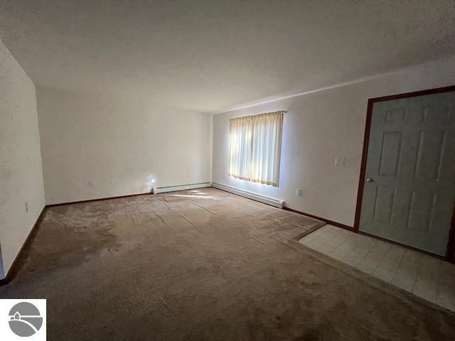 interior space with a baseboard radiator and carpet floors