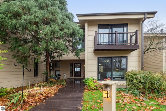 back of property with a balcony