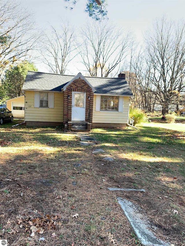 ranch-style house featuring a garage and a front yard