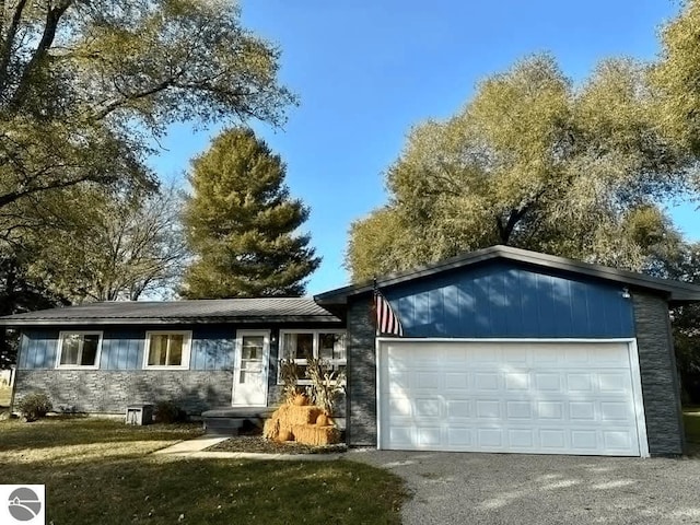 ranch-style house with a garage and a front yard