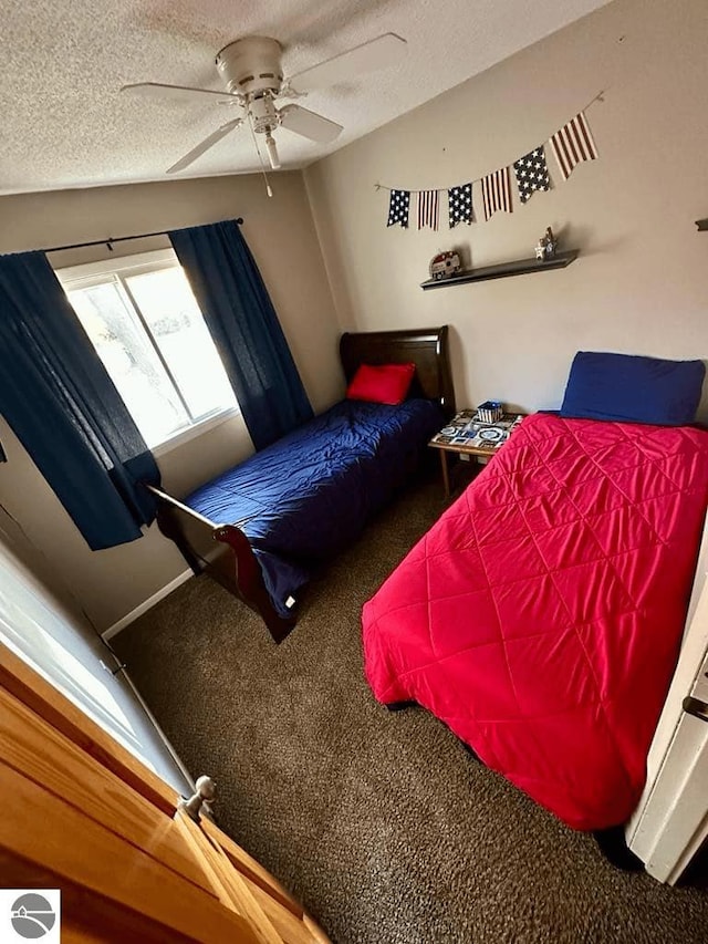 carpeted bedroom featuring a textured ceiling and ceiling fan