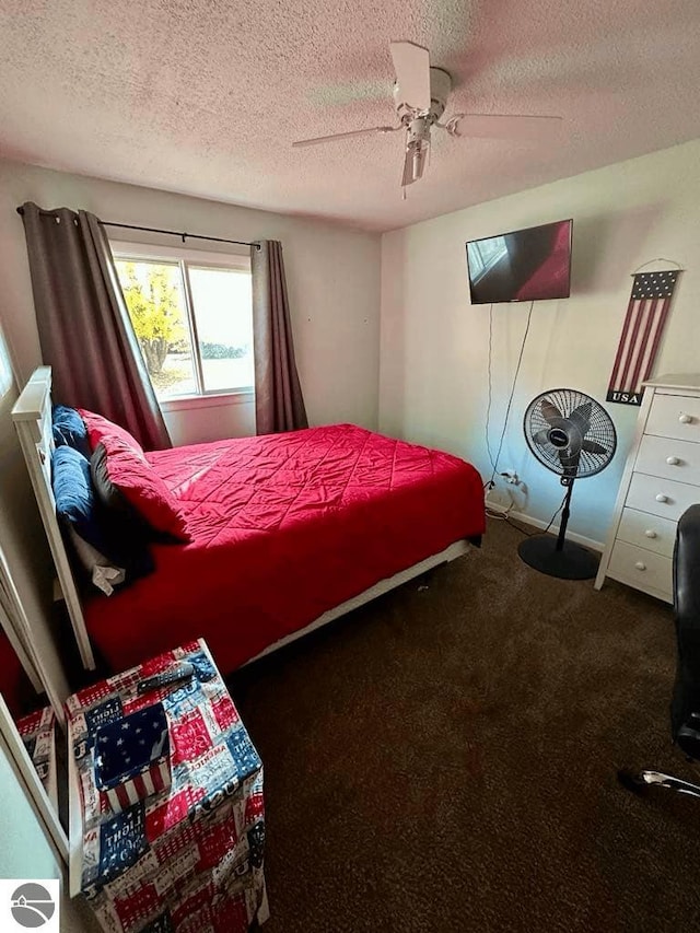 bedroom with a textured ceiling, carpet, and ceiling fan