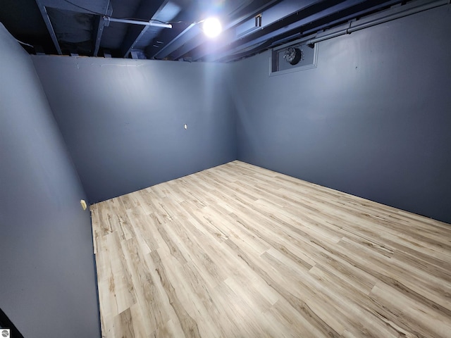 basement with light hardwood / wood-style floors